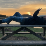 Traveler using phone at campground.