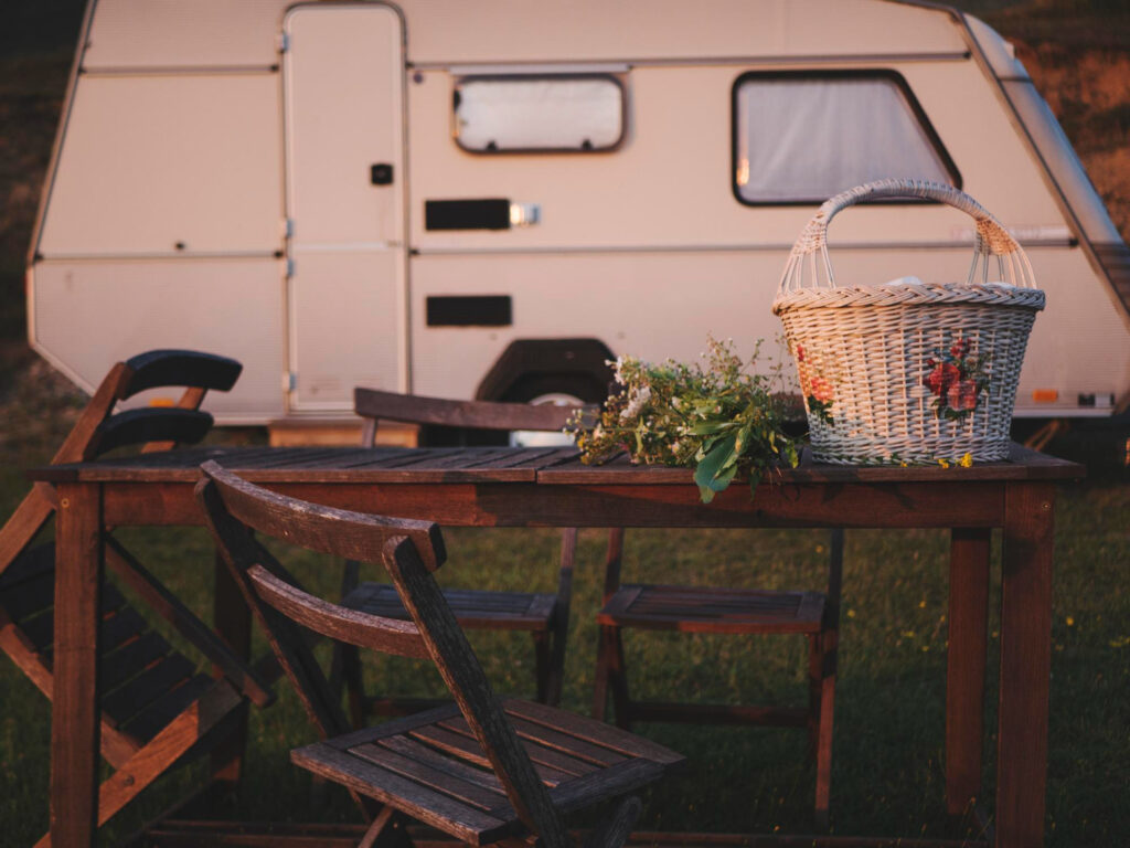 a white campground in the mountains with a cute table and flowers