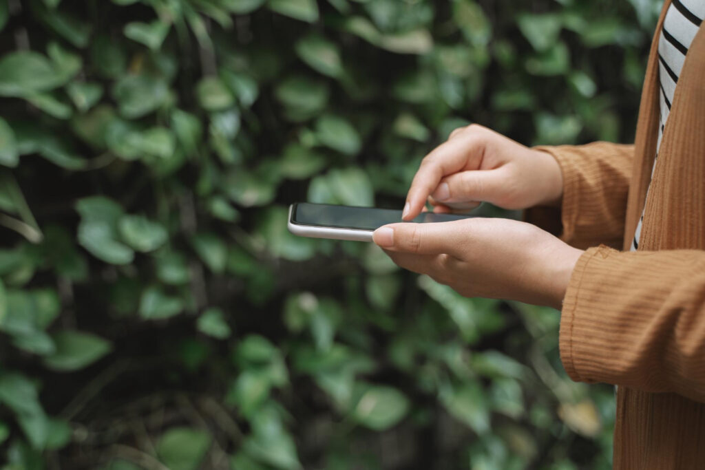 Woman reading the availability of a campground on her phone 