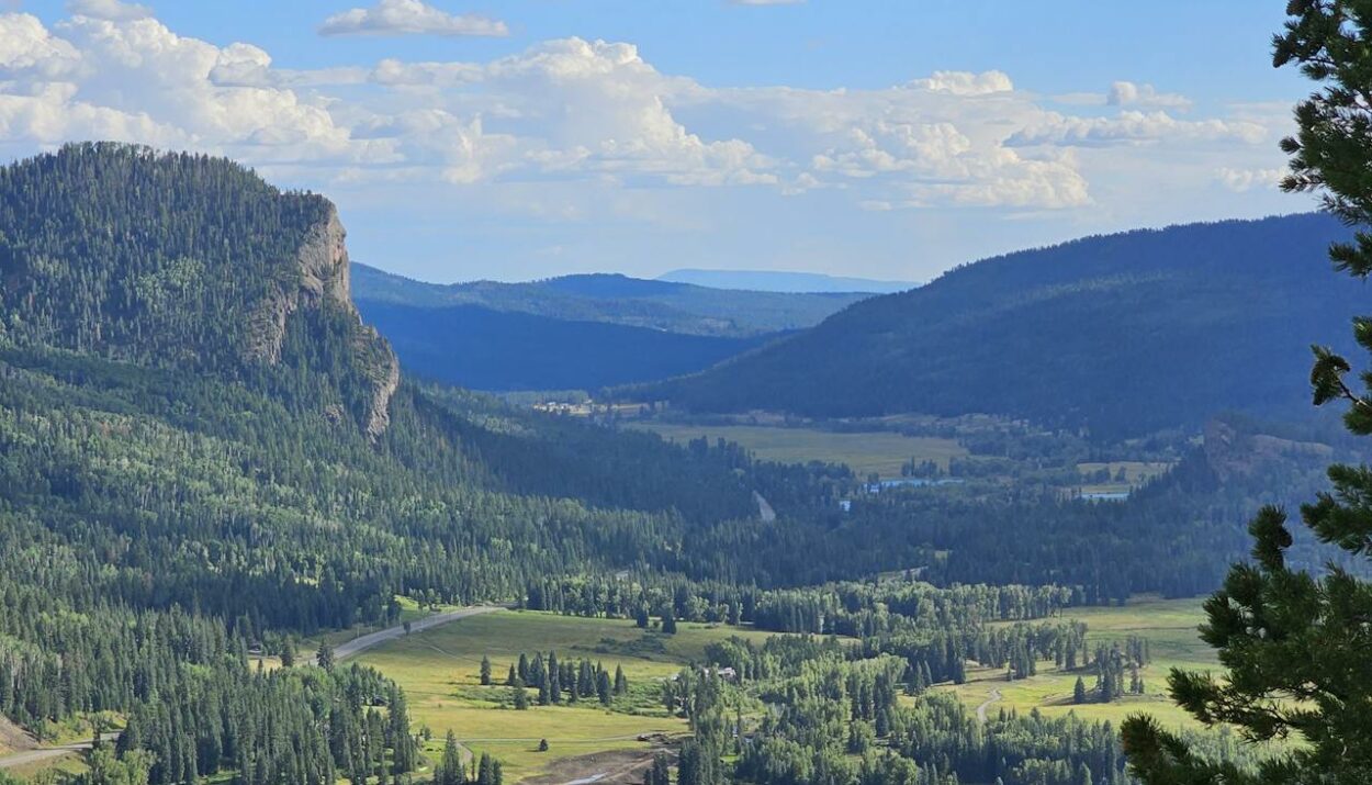 A blue sky with mountains and a river nearby