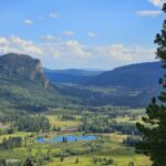 A blue sky with mountains and a river nearby