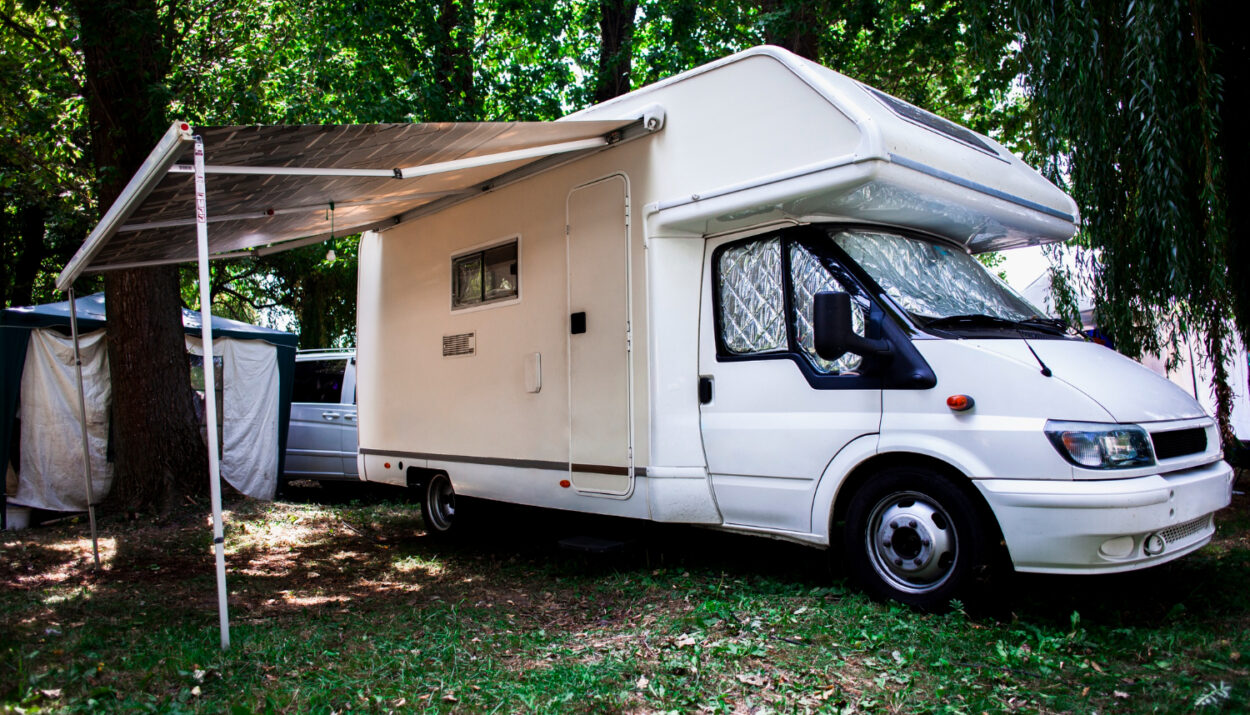 A white camper van in its camprground spot