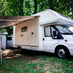 A white camper van in its camprground spot