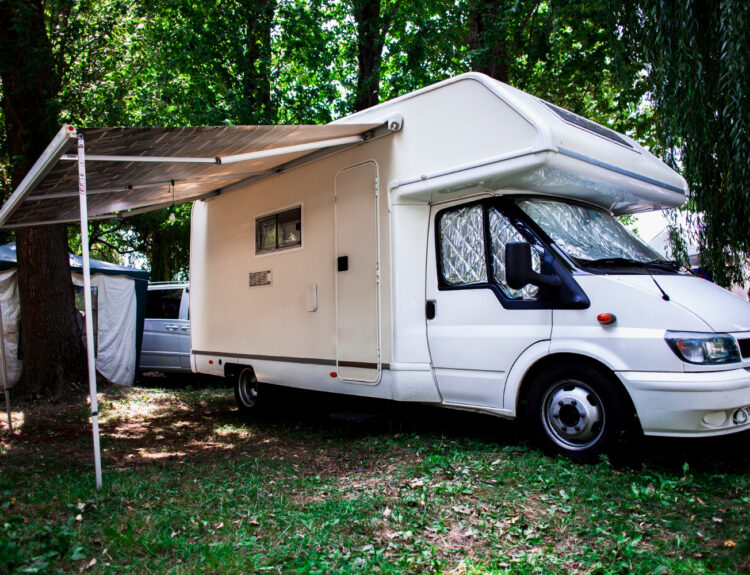 A white camper van in its camprground spot