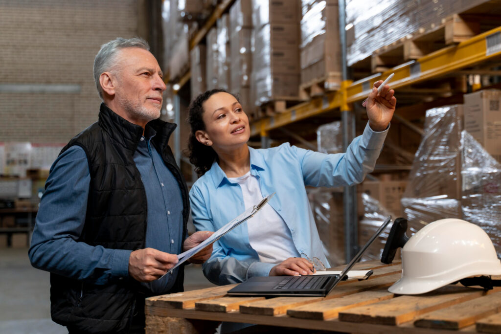  a blue shirt and a black jacket with no sleeves and a woman with a blue shirt inside an inventory building