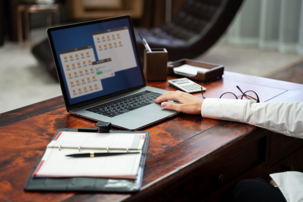 A man using a laptop managing the reservation system of his campground