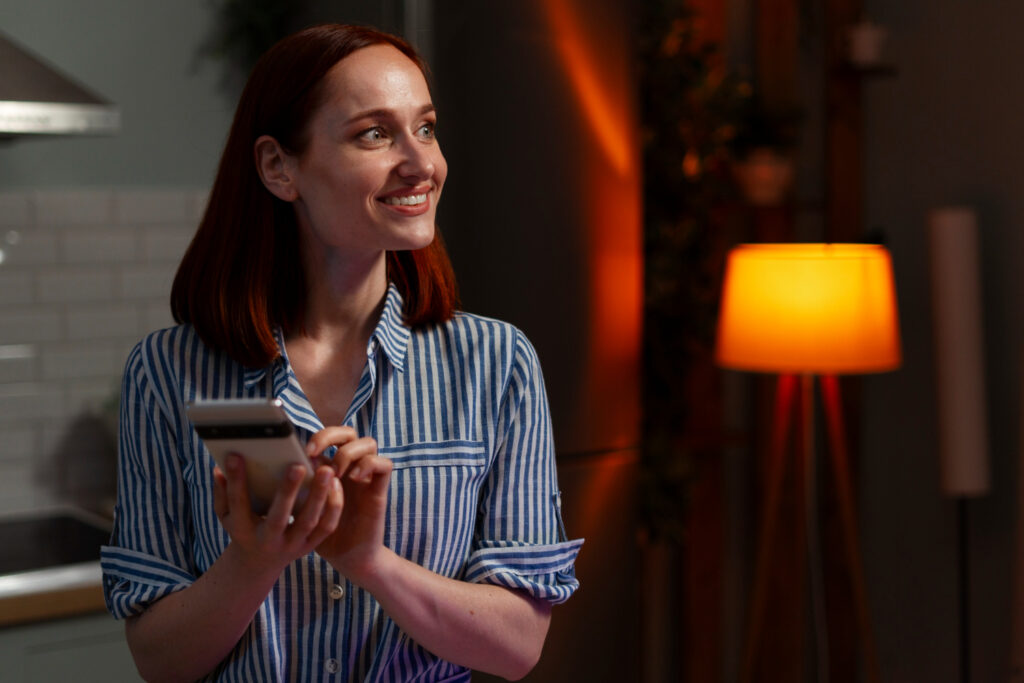 Woman in a blue and white shirt using her phone 