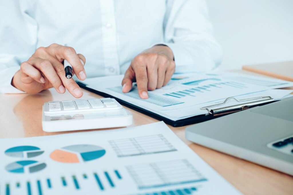 Man with metrics in a table and a calculator managing the budget for a campground 