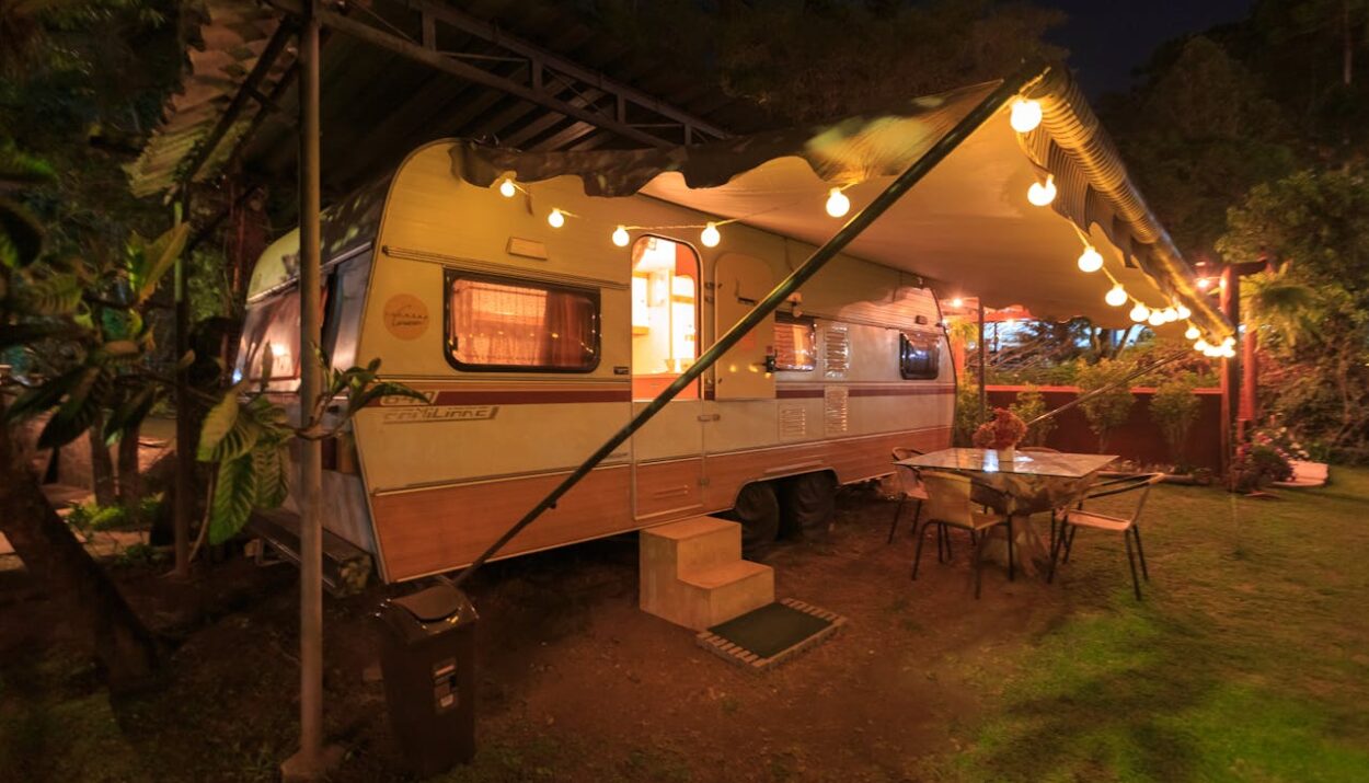 Beige and white campground with lights in front at night