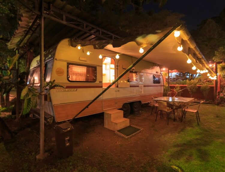 Beige and white campground with lights in front at night