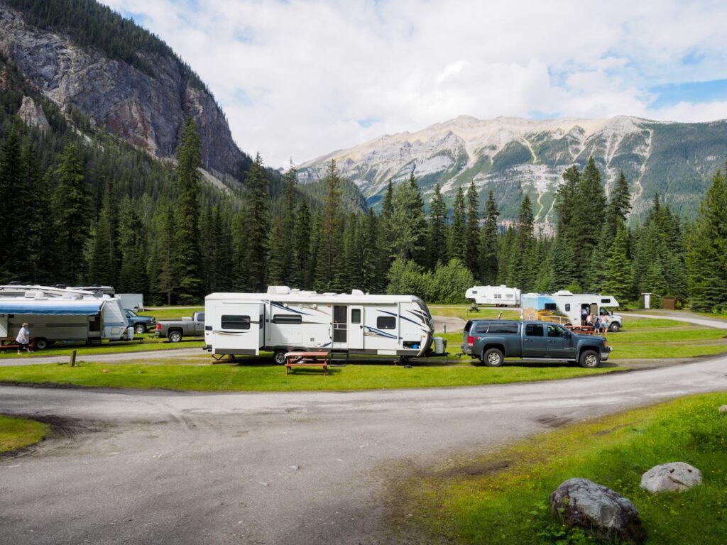 A group of camper van in a campground slot on the mountains