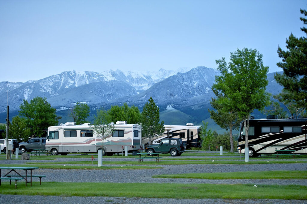 A group of campere vans in their respective spots of RV park 