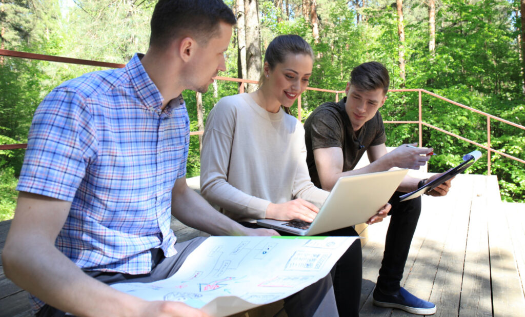 three prople checking the marketing strategy of their RV park using campsite management software 