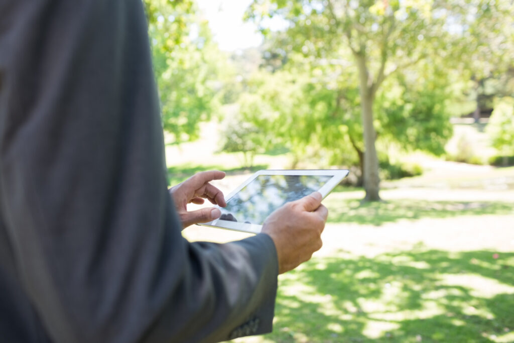 A person using a tablet to make a secure payment using campground booking software