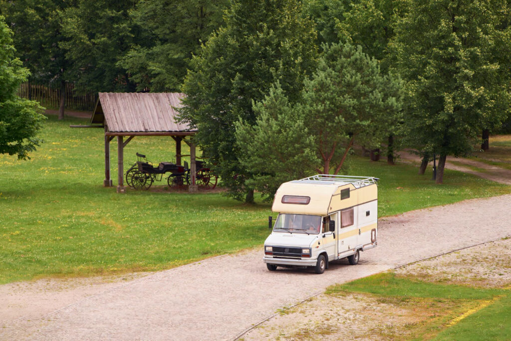 a white and yellow camper van on the road 