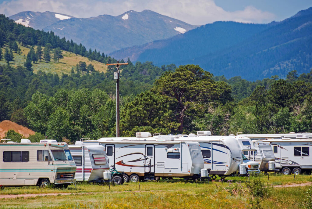 A group of camper vans in a campsite in the mountains 