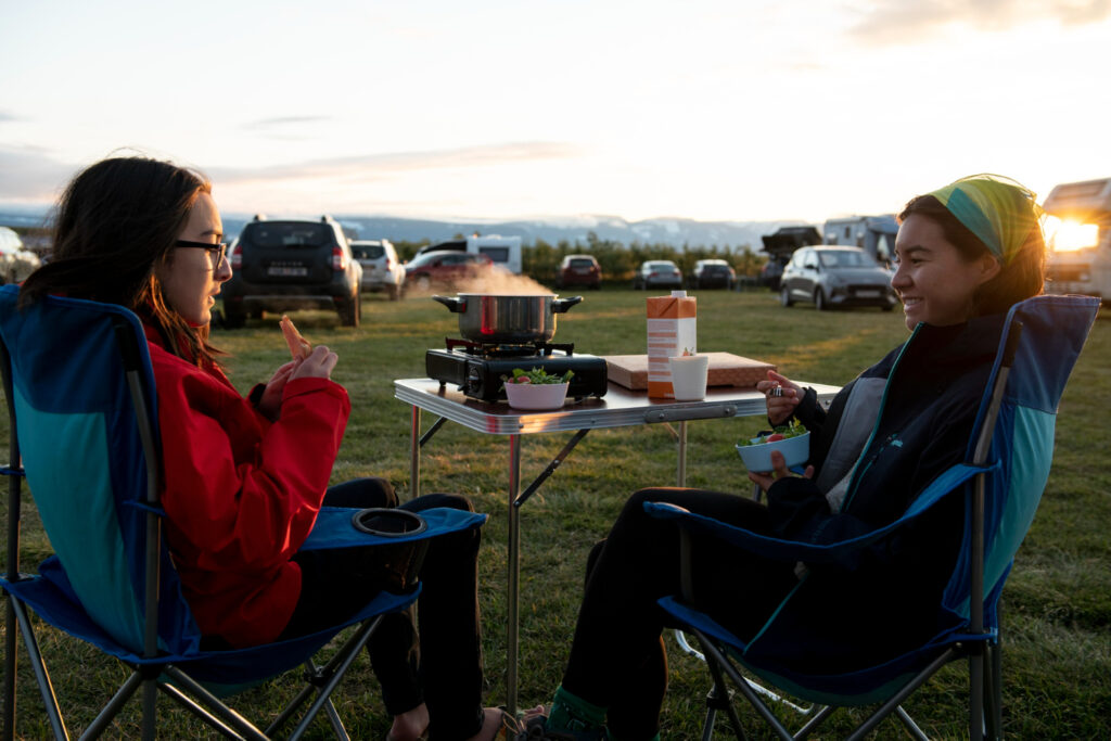 two friends enjoying a meal in a rv park they stayed using campground reservation software