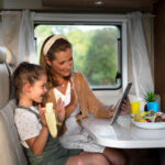 a mother teaching her daugther while in a camper van