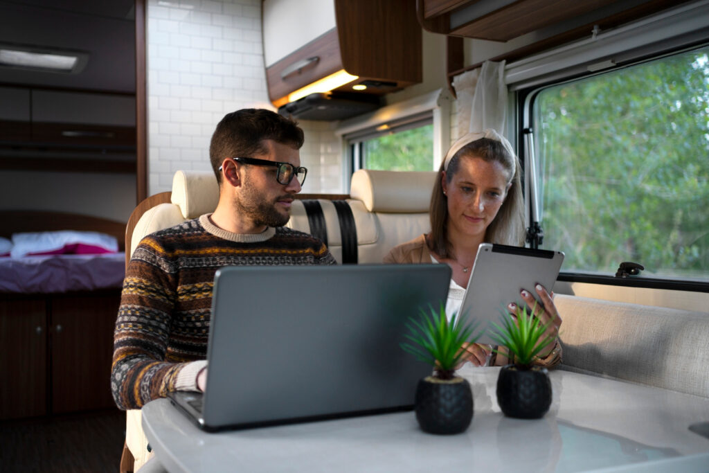 two people using a laptop and a tablet checking the customer satisfaction and establishing a marketing campaign for their RV park