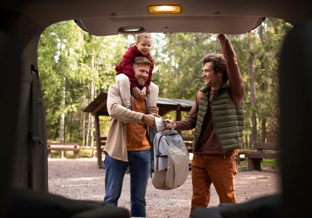 two men and a little child packing for their RV park stay