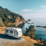 a high ground point of view of a camper van on the edge of a cliff with the ocean in front of it