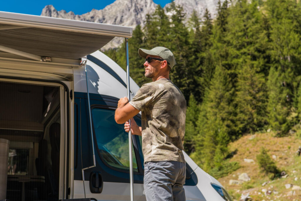 a customer of a RV park expanding his camper van in his camping spot