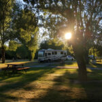 a camper van on their respective campsite spot of an RV park