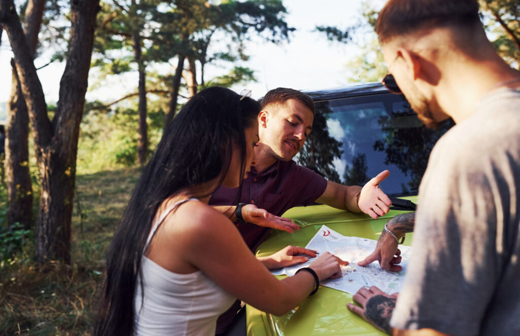 a group of people site maping their campsite 