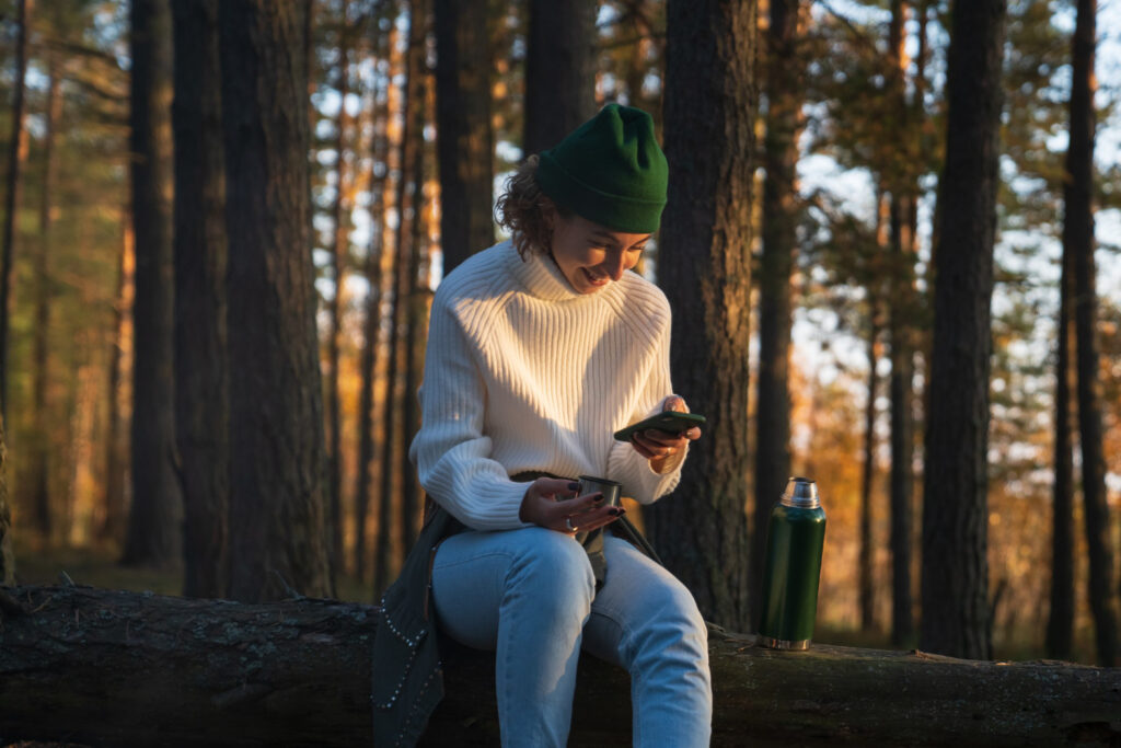 A woman learning how to use a campground management software on her phone 