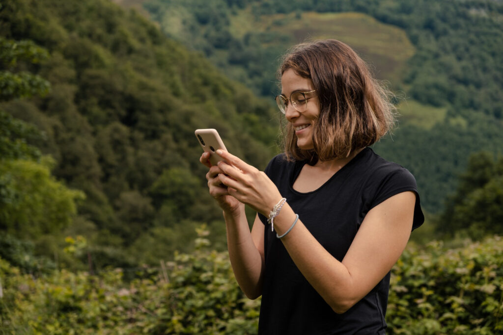 a woman giving receiving a notifications of her RV park using camping management software