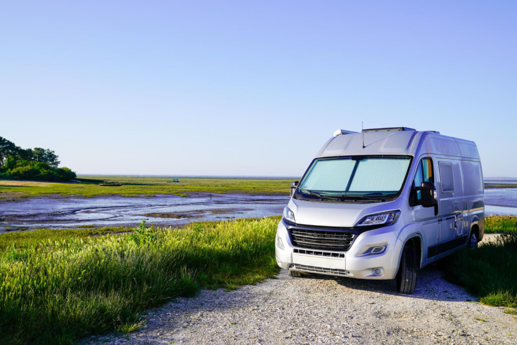 A grey campground in nature with a blue sky behind it 