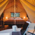 A focused view of a laptop outside of a glamping site