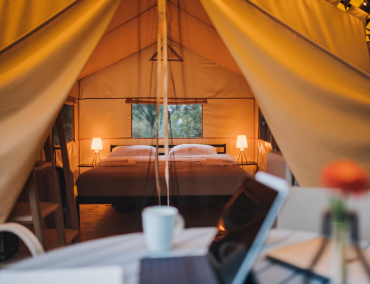 A focused view of a laptop outside of a glamping site