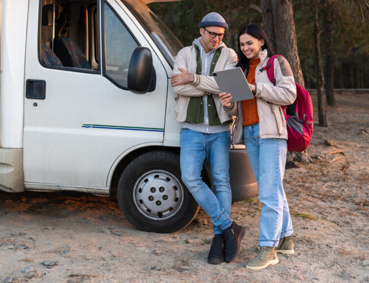 two people looking at a tablet using reservations software for an RV park