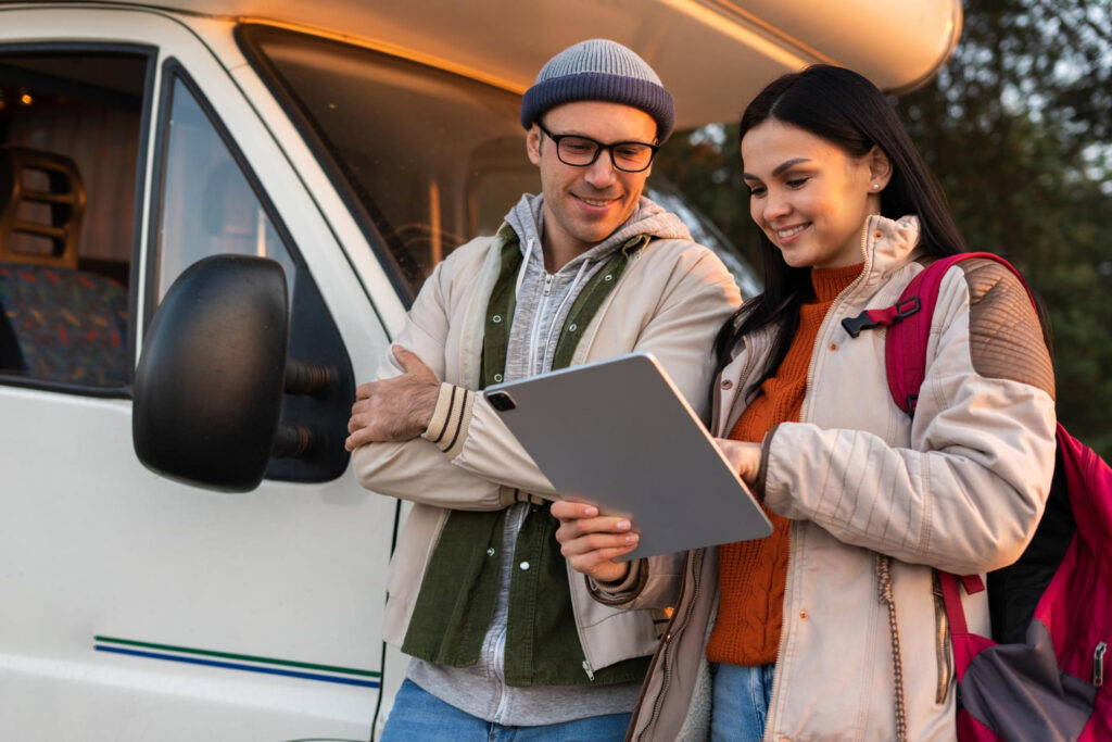 two people watching a tablet to make a reservation using RV park software