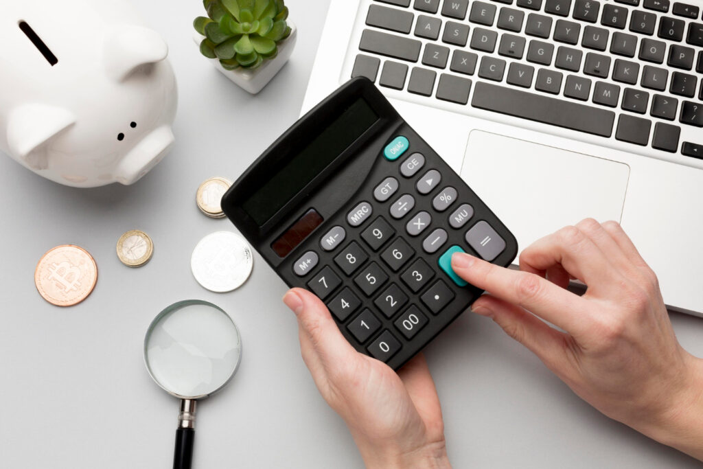 a person using a calculator to see the dynamic pricing of his RV park 