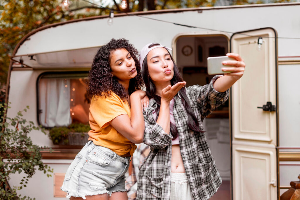 Two girls taking pictures on their RV park spot thanks to rv park software