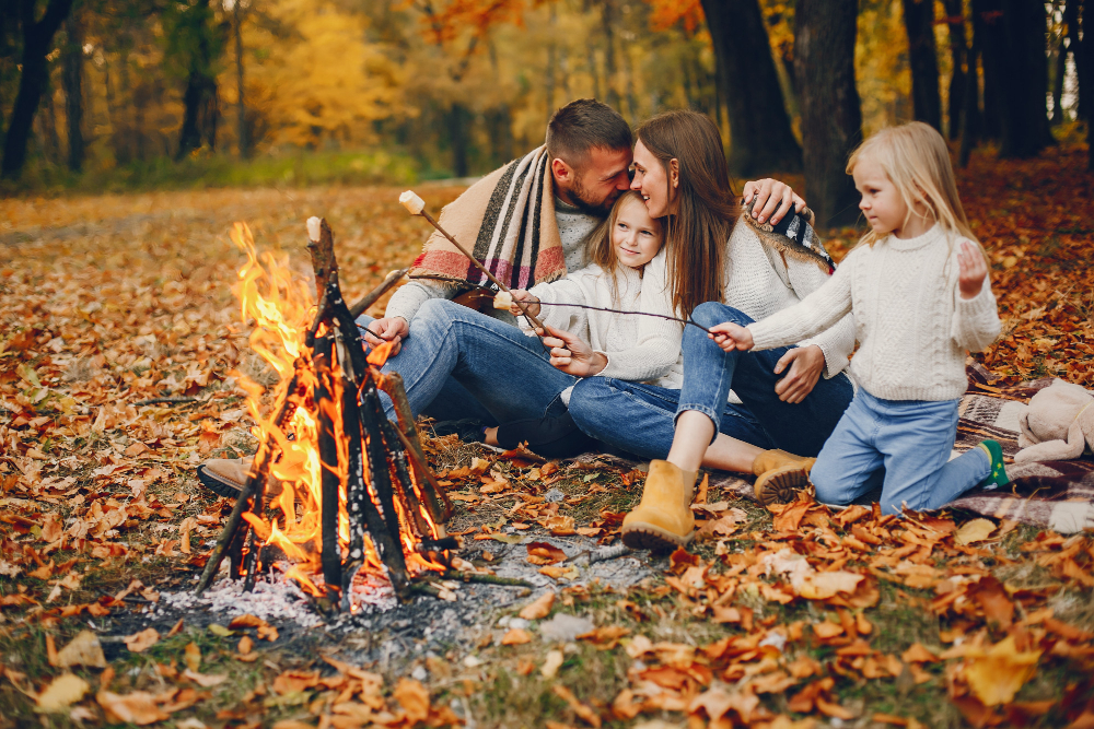 a family enjoying a fall camping trip in the forest