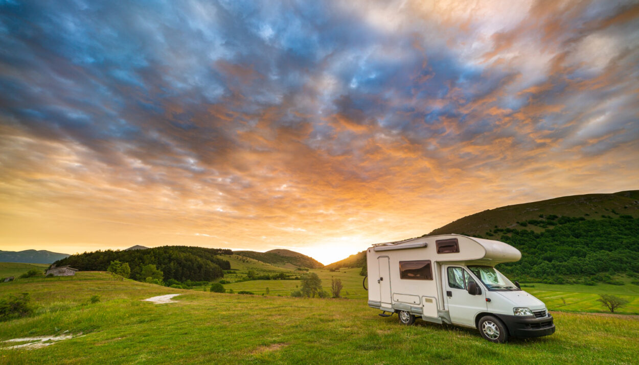 A beautiful view of a camper van in the sunset