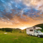 A beautiful view of a camper van in the sunset