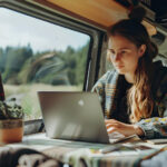 a woman checking her laptop to see her long-term stay in an RV park