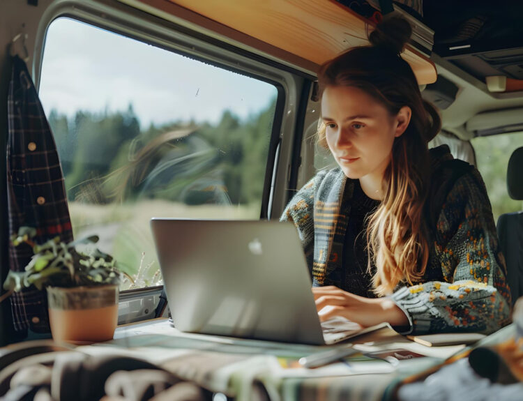 a woman checking her laptop to see her long-term stay in an RV park