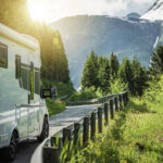 a camper van driving on the road to their next RV park reservation