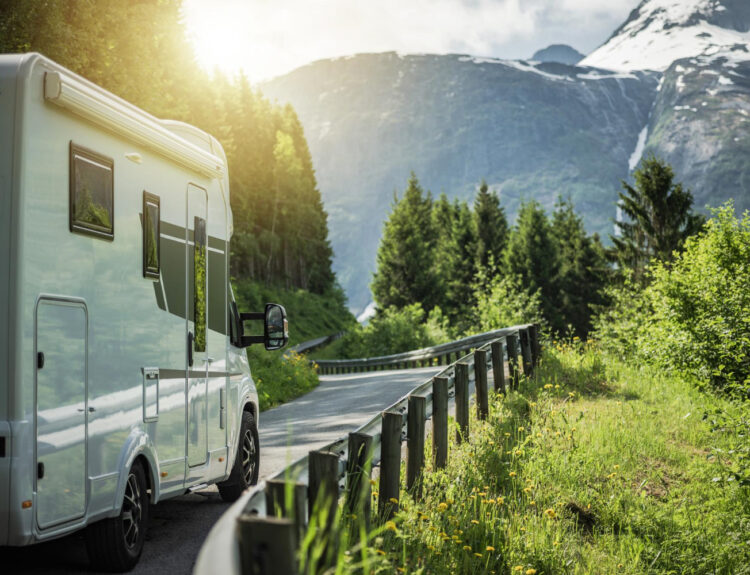 a camper van driving on the road to their next RV park reservation