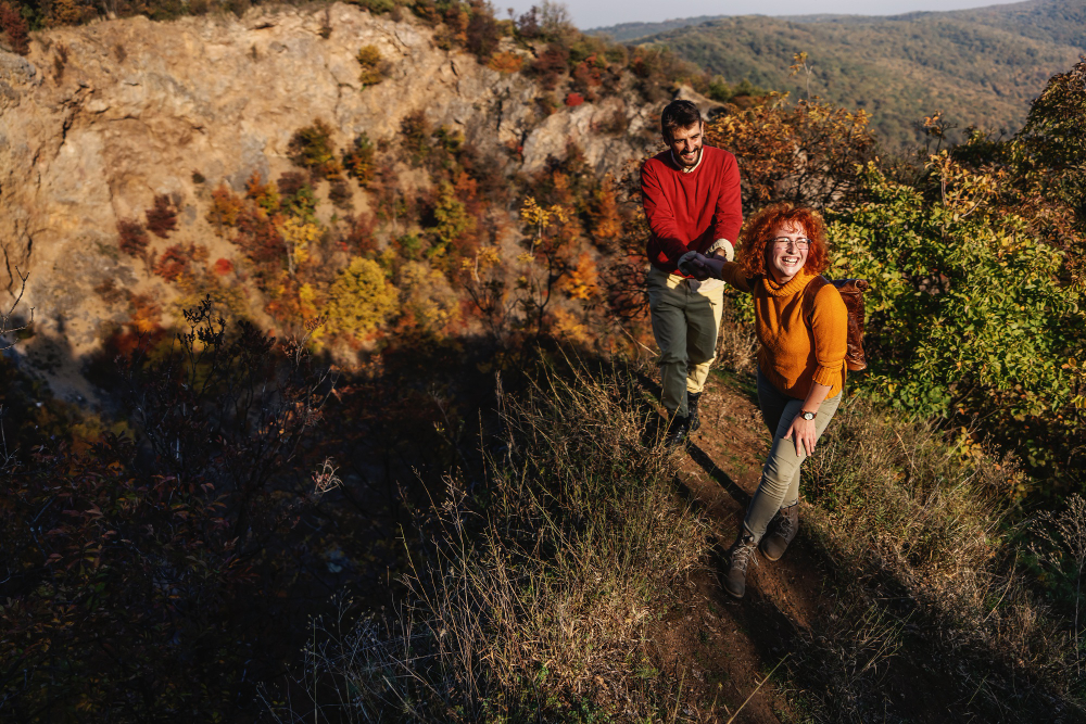 two people hiking up a mountain in the fall 