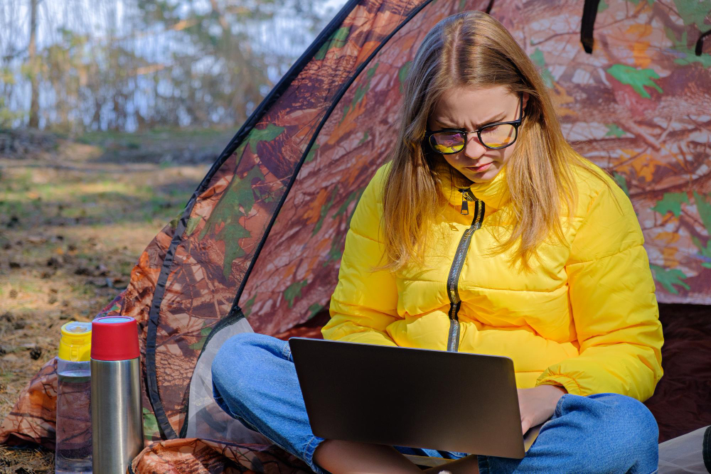 a woman in a yellow jacket in the forest marketing her RV park as a group-friendly campground for her guests